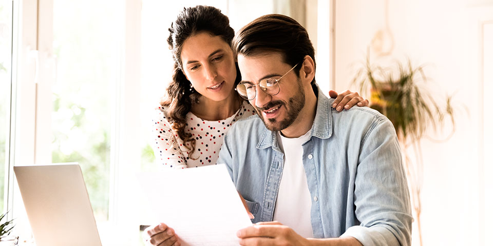 Male and female couple viewing a document