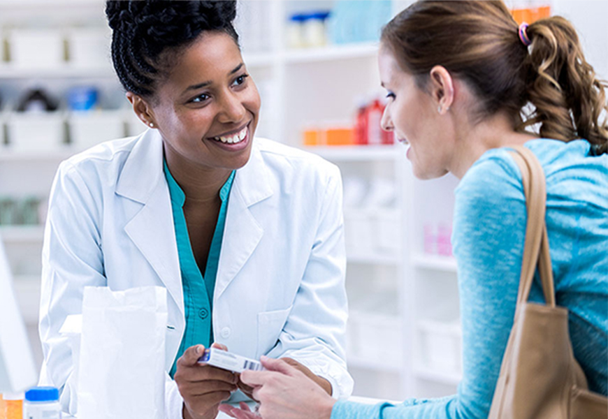 Female pharmacist speaking with a female patient about a prescription