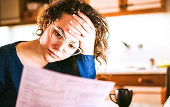 Woman reviewing document looking stressed