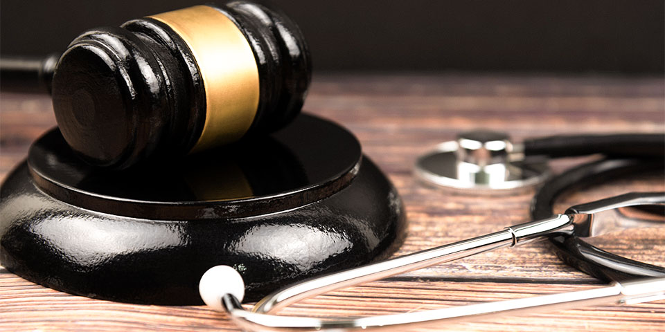 stethoscope laying on a desk next to medical device