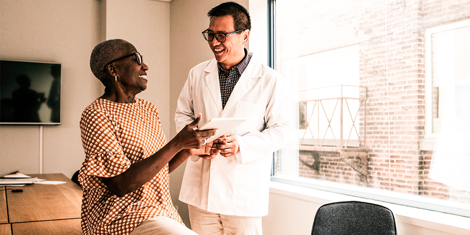 Adult female in conversation with male healthcare provider in a healthcare setting