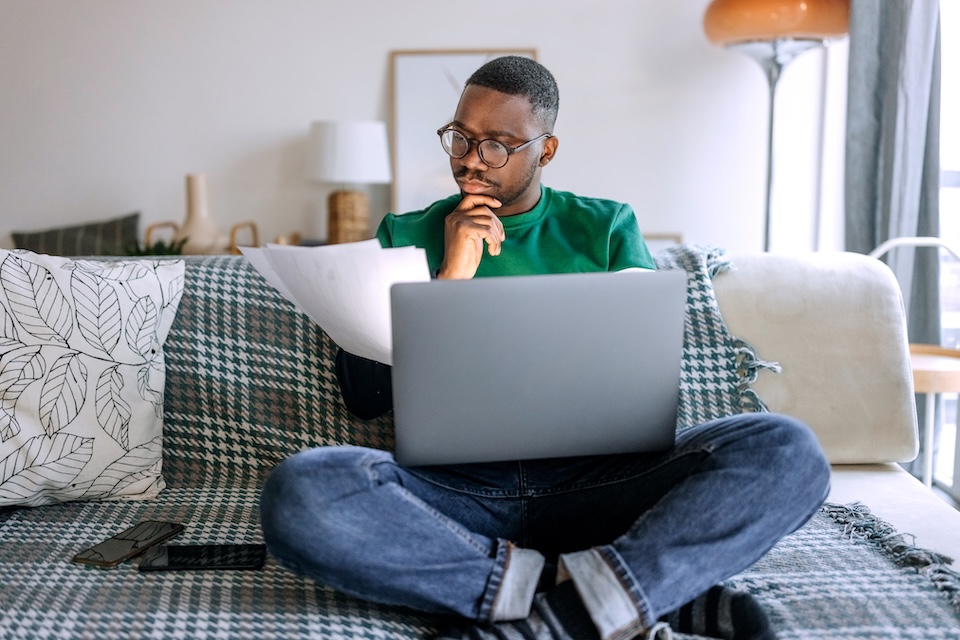 Man looking at laptop screen at home
